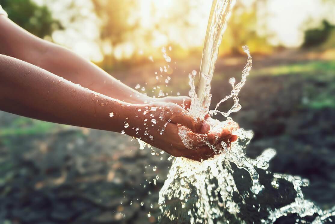 hand cupping water from a tap